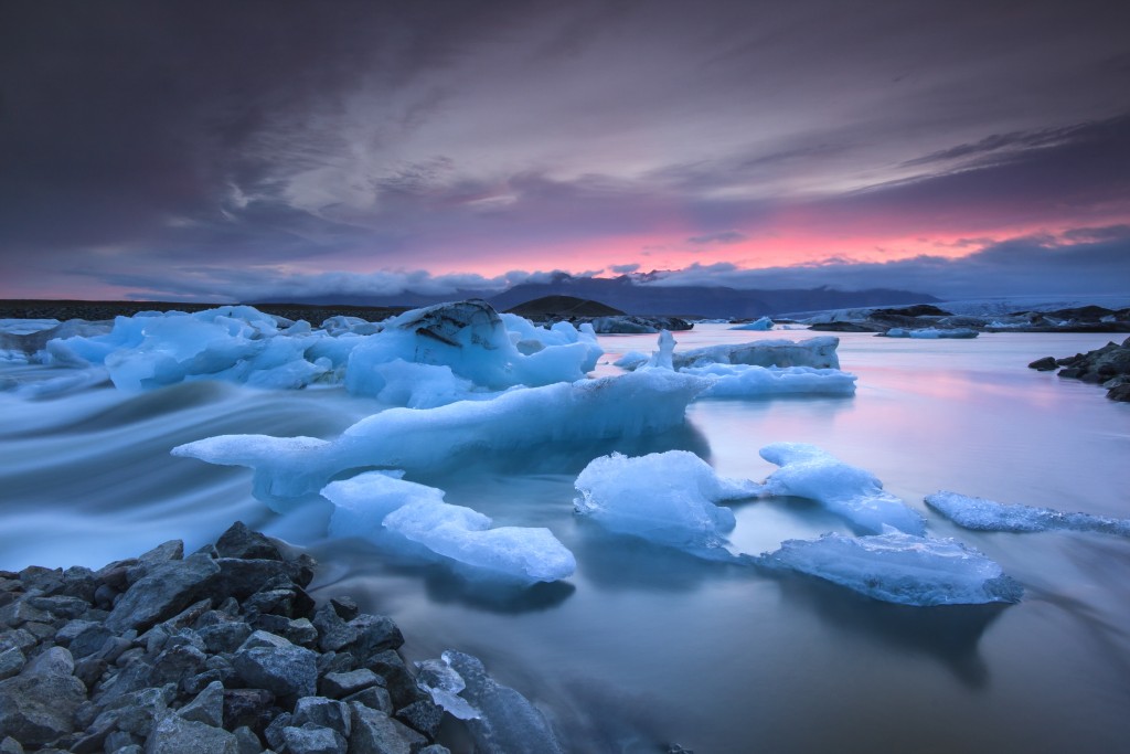 Icebergs floating in Jokulsarlon glacier lake at sunset